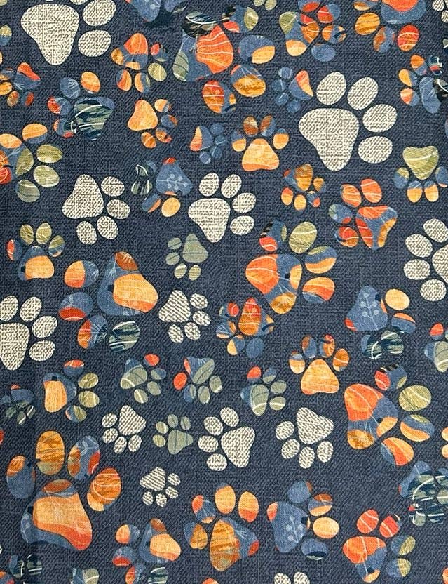 Pattern of colorful paw prints on a blue background