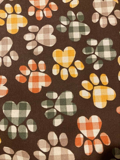 Pattern of plaid paw prints on a brown background