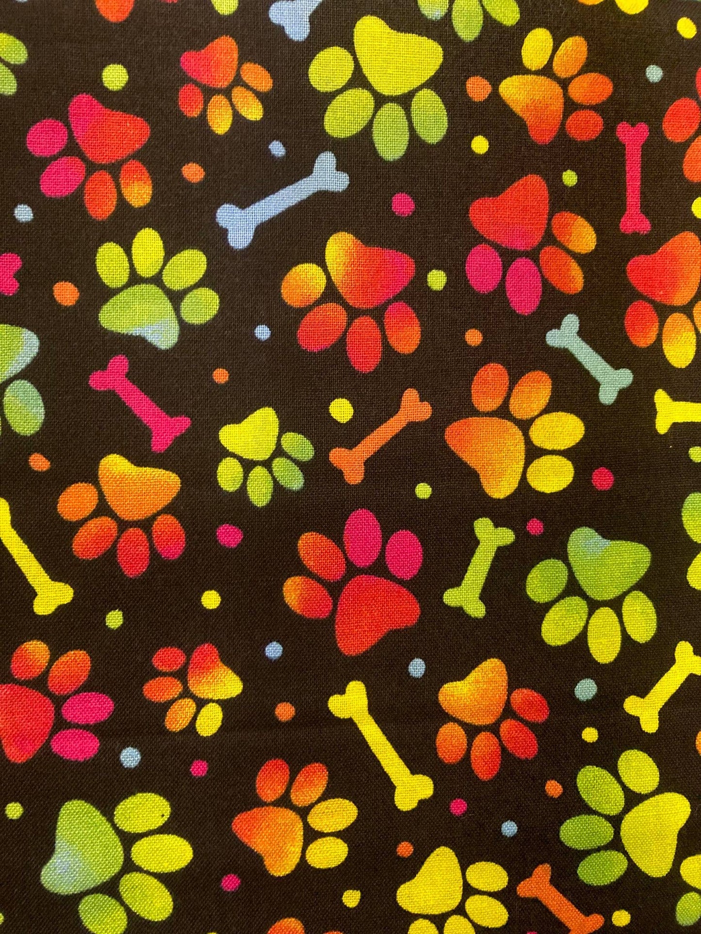 Colorful paw prints and bones pattern on a black background