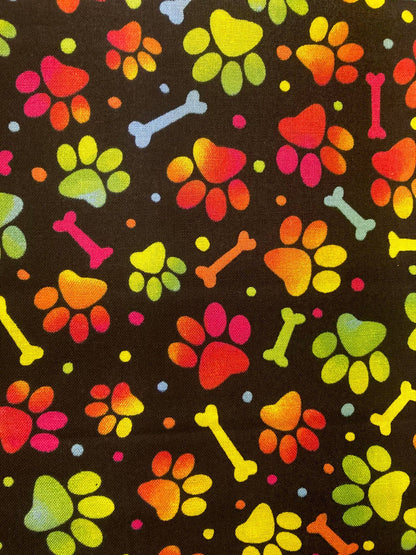 Colorful paw prints and bones pattern on a black background