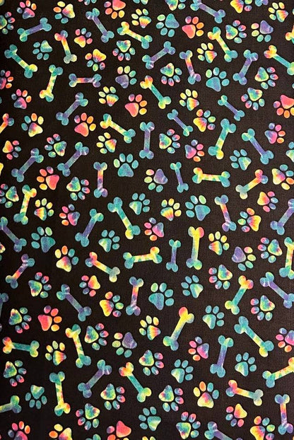 Colorful pattern of bones and paw prints on a black background