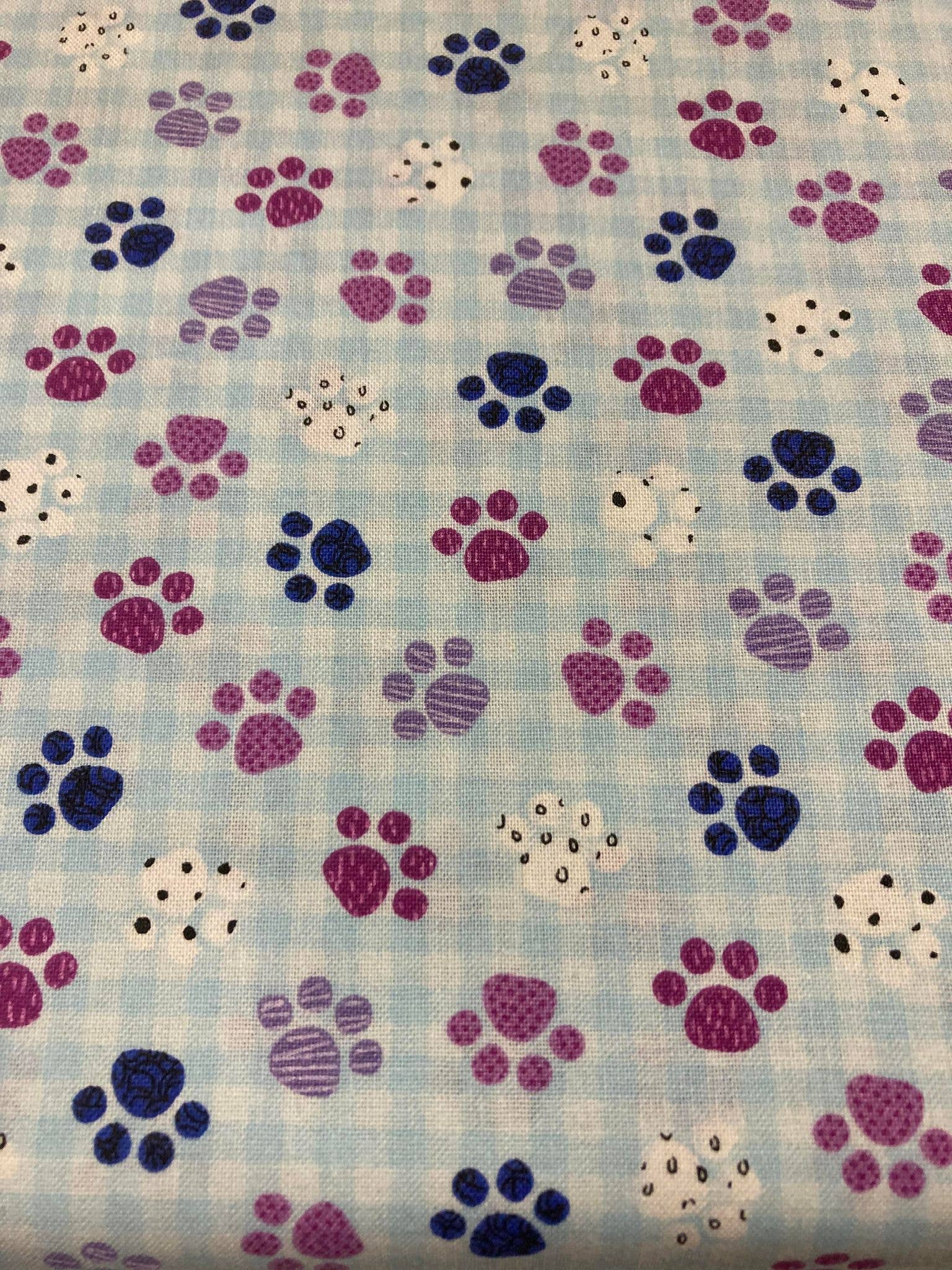 Pattern of colorful paw prints on a checkered background