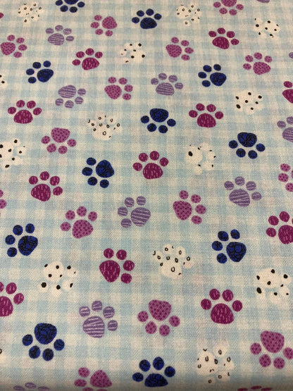 Pattern of colorful paw prints on a checkered background