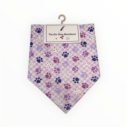 Dog bandana with paw print pattern on a checkered background, displayed on a hanger.