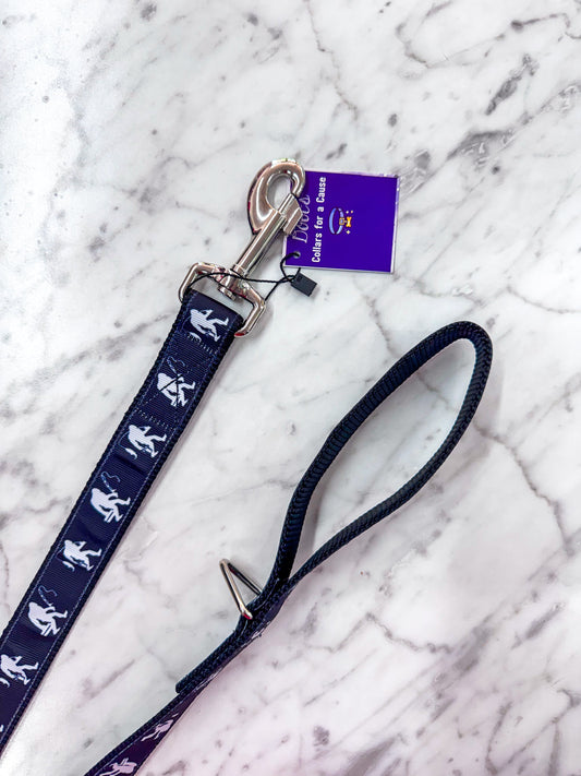 Navy blue dog leash with white illustrations on a marble surface