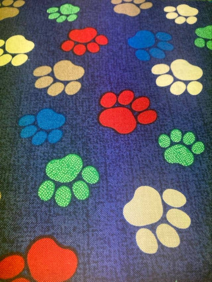 Colorful paw prints on a dark blue background