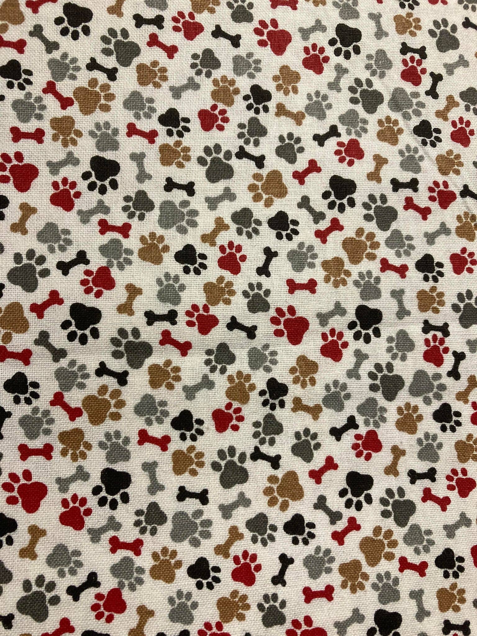 Pattern of dog paw prints and bones on a beige background