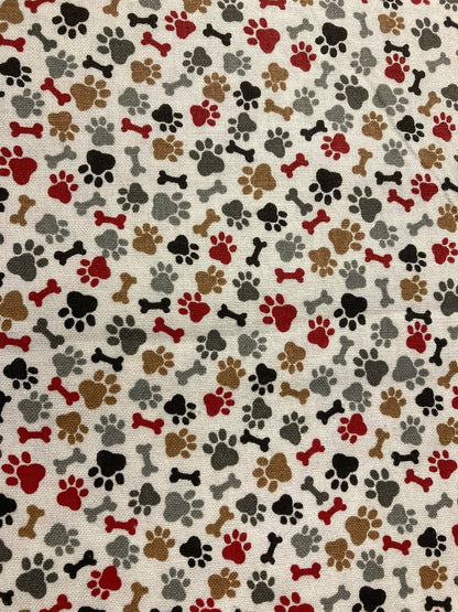 Pattern of dog paw prints and bones on a beige background