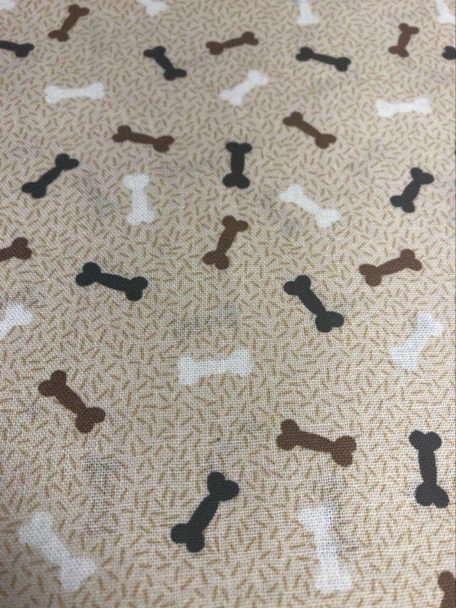 Pattern of dog bones on a textured beige background